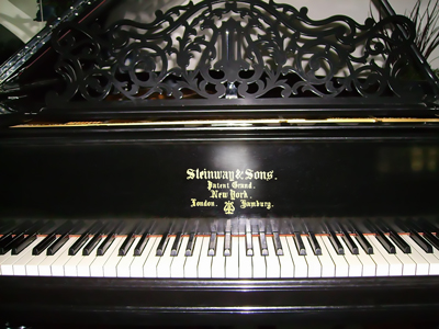 A close up of the front of a rebuilt piano.