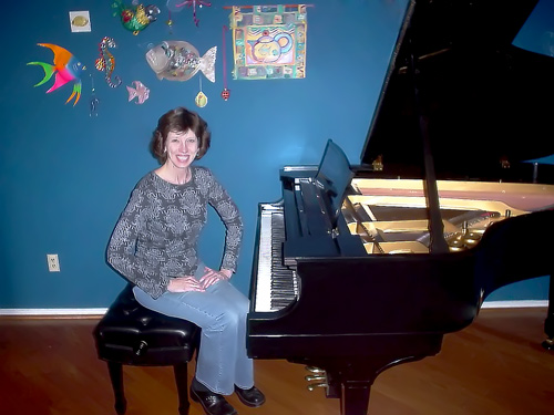 Satisfied customer sitting at her newly rebuilt piano.